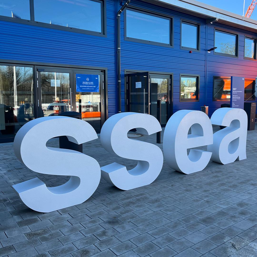 ACS logo outside the facility during participation in the SSEA Symposium in Monaco