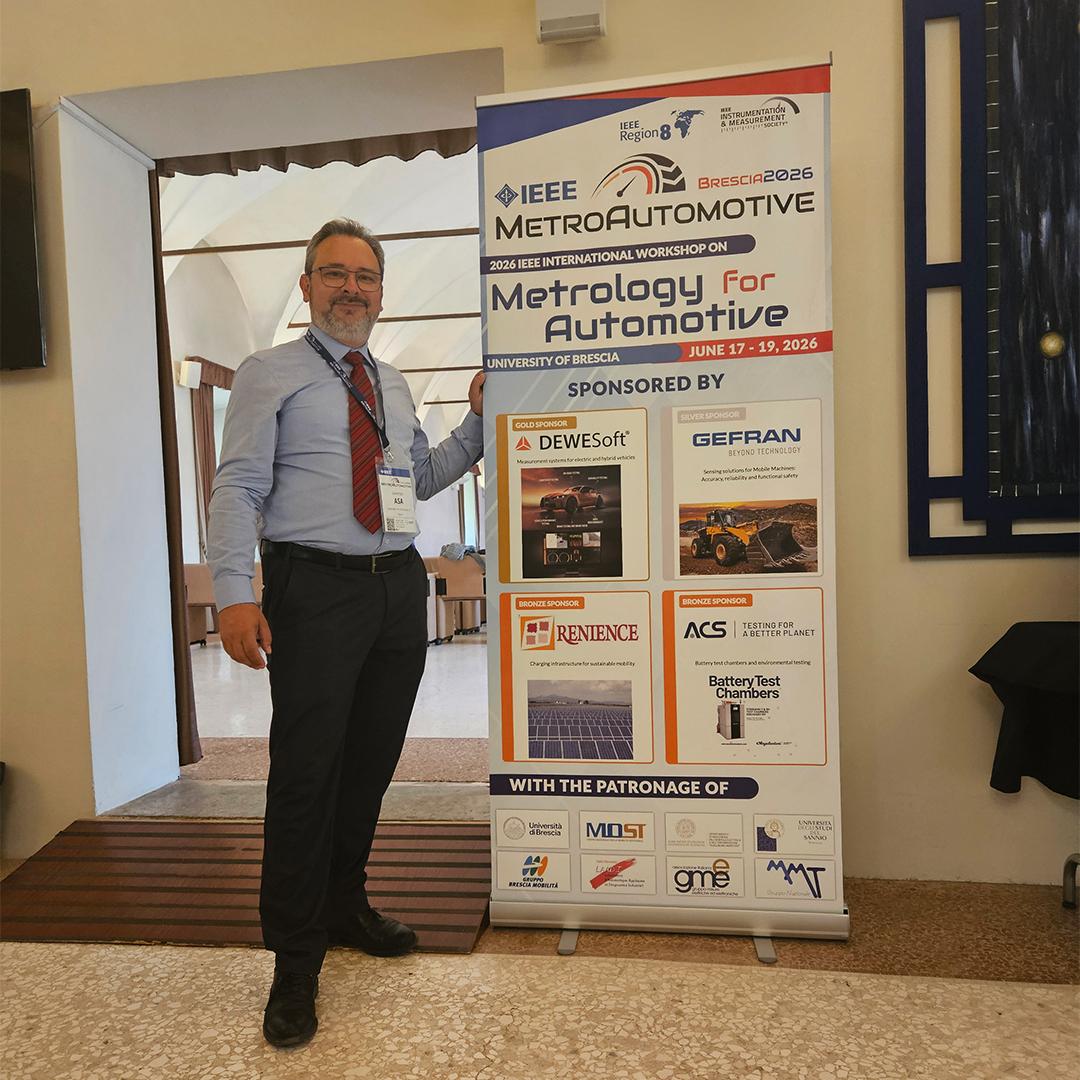 ACS representative next to the IEEE MetroAutomotive 2026 banner at the University of Brescia